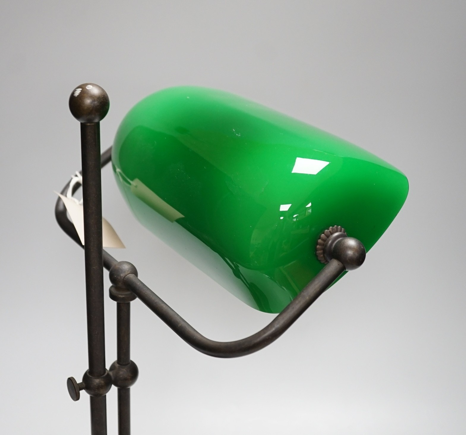 A green glass and brass student lamp, 48cms high